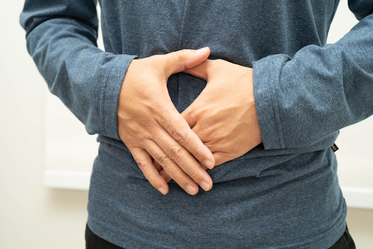 Hernia pain, Asian man abdominal pain.