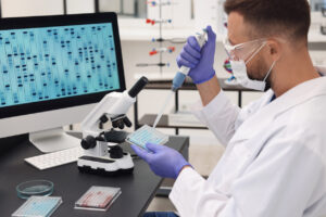 Research in genetics. Scientist with micropipette and microplate working at table in laboratory